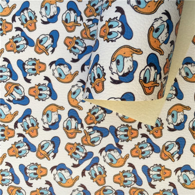 Donald Duck Printed Faux Leather Sheet Litchi has a pebble like feel with bright colors